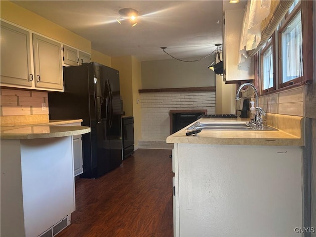 1046 Ammon Rd, Lewis, NY 13489 - kitchen featuring black fridge, dark wood-type flooring, light countertops, decorative backsplash, and stove