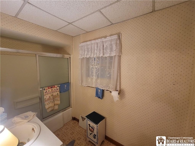 421 Falconer St, Jamestown, NY 14701 - bathroom featuring a paneled ceiling, bath / shower combo with glass door, and vanity