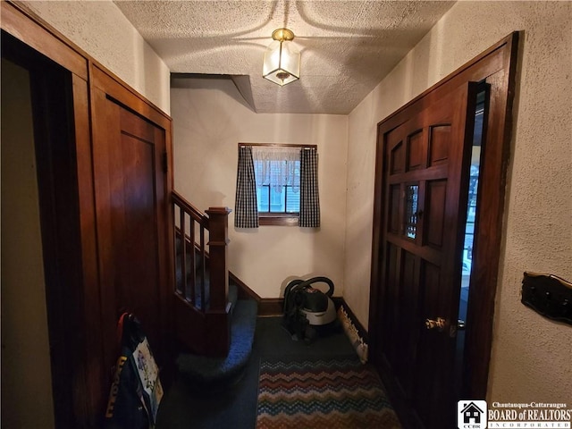 421 Falconer St, Jamestown, NY 14701 - carpeted foyer featuring a textured ceiling, a textured wall, and stairway
