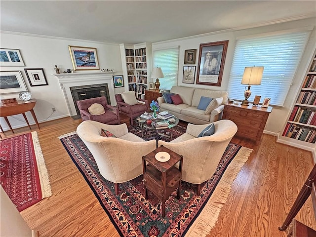 10 Danbury Cir N, Brighton, NY 14618 - living area featuring wood finished floors, built in features, a fireplace with flush hearth, and crown molding