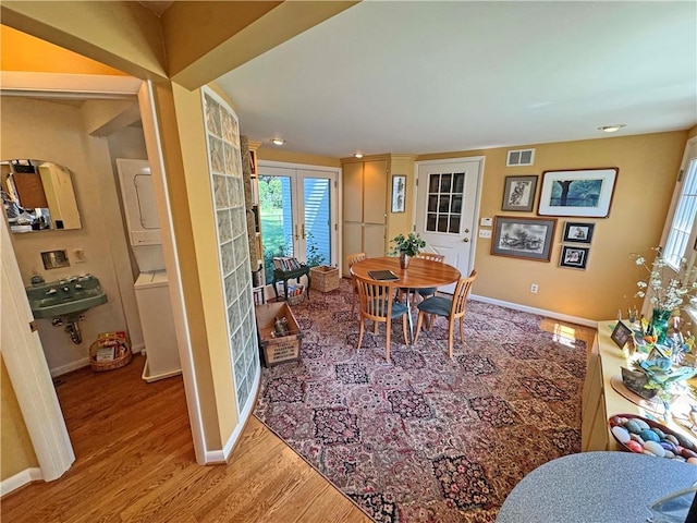 10 Danbury Cir N, Brighton, NY 14618 - dining area featuring stacked washer / dryer, light wood-style floors, and recessed lighting