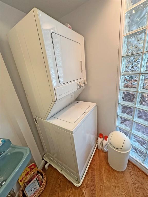 10 Danbury Cir N, Brighton, NY 14618 - washroom featuring stacked washer / dryer and wood finished floors