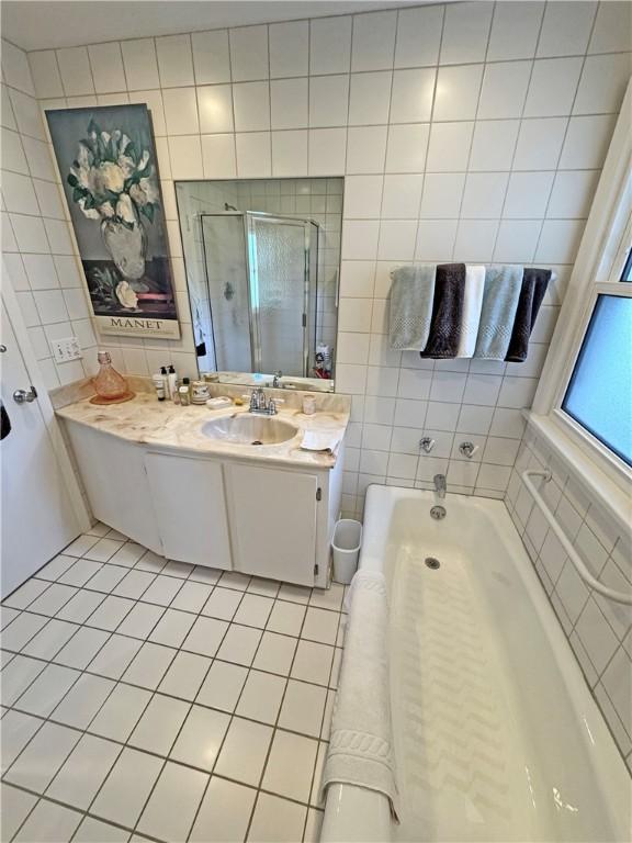 10 Danbury Cir N, Brighton, NY 14618 - full bathroom featuring tile walls, tile patterned flooring, vanity, a bath, and a shower stall