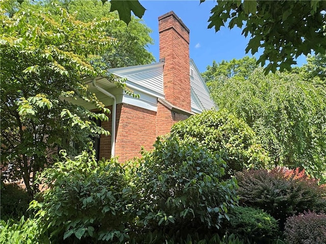 10 Danbury Cir N, Brighton, NY 14618 - view of side of property with a chimney and brick siding