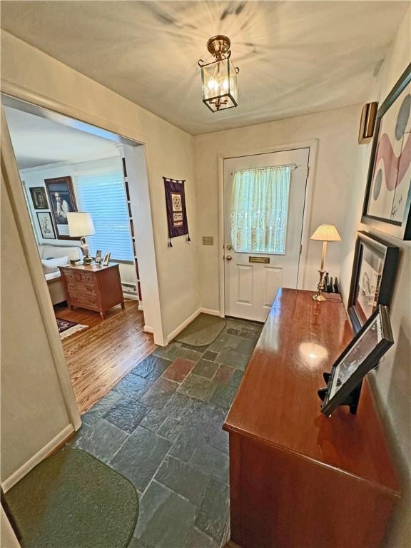 10 Danbury Cir N, Brighton, NY 14618 - foyer entrance with stone tile floors and a chandelier