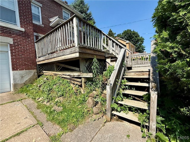 633 Pleasant St, Utica, NY 13501 - view of side of home featuring a deck and brick siding