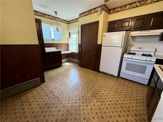 633 Pleasant St, Utica, NY 13501 - kitchen with white appliances, a baseboard radiator, a wainscoted wall, under cabinet range hood, and dark brown cabinets