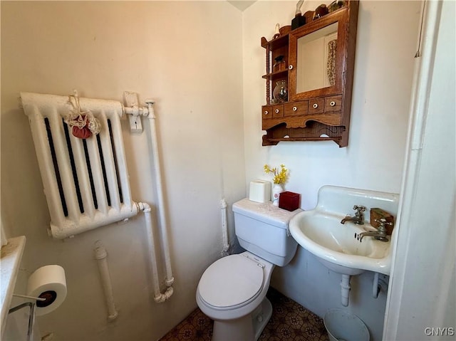 633 Pleasant St, Utica, NY 13501 - half bath with radiator heating unit and toilet