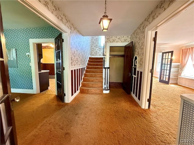 633 Pleasant St, Utica, NY 13501 - hallway with wallpapered walls, carpet floors, and stairs