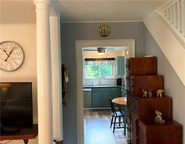 74 Cleveland Ave, Elmira, NY 14905 - kitchen featuring wood finished floors, backsplash, ornate columns, and blue cabinets