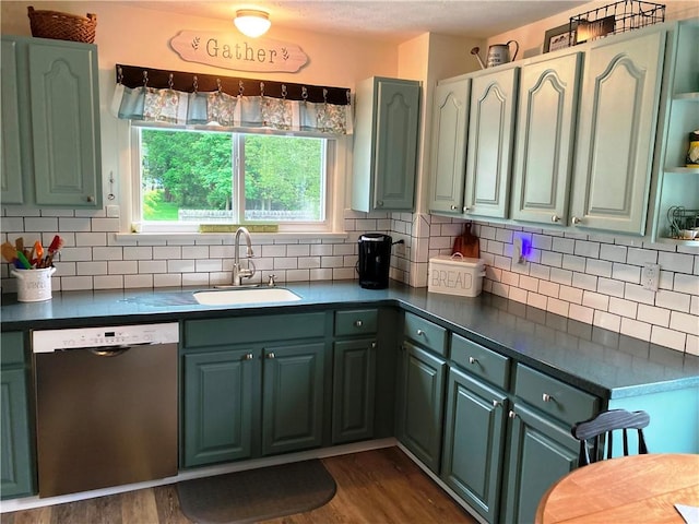 74 Cleveland Ave, Elmira, NY 14905 - kitchen with stainless steel dishwasher, dark countertops, green cabinets, and plenty of natural light