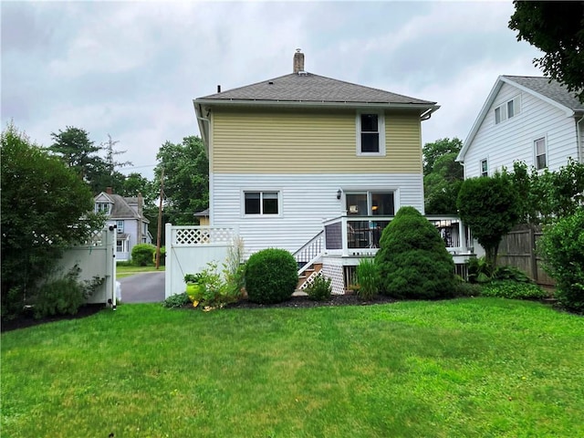 74 Cleveland Ave, Elmira, NY 14905 - back of house featuring a chimney and a wooden deck