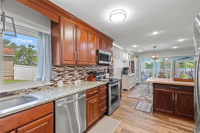 13 E Edgewater Dr, Fulton, NY 13069 - kitchen featuring stainless steel appliances, light wood-style flooring, plenty of natural light, backsplash, and recessed lighting