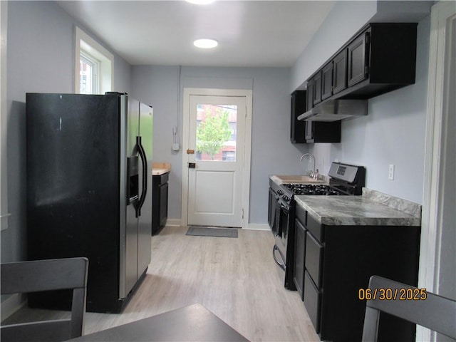 4 Geneva St, Lyons, NY 14489 - kitchen featuring black fridge with ice dispenser, stainless steel gas stove, dark cabinets, and light wood-style flooring