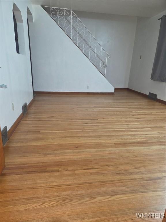465 18th St, Niagara Falls, NY 14303 - unfurnished living room with wood finished floors and stairway