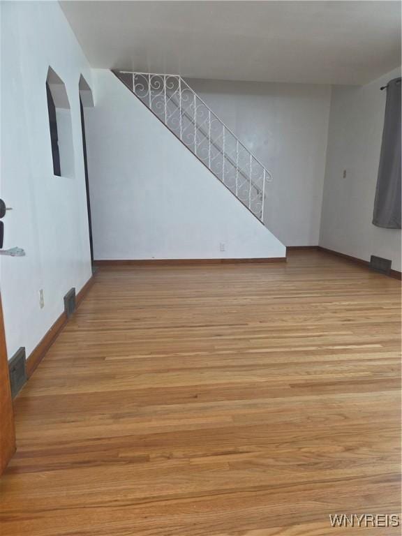 465 18th St, Niagara Falls, NY 14303 - spare room featuring wood finished floors and stairway