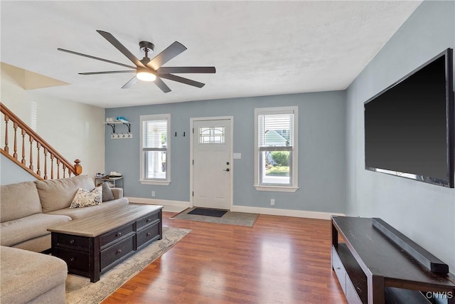 230 Thieme Pl, Utica, NY 13502 - living area with ceiling fan, wood finished floors, and stairway