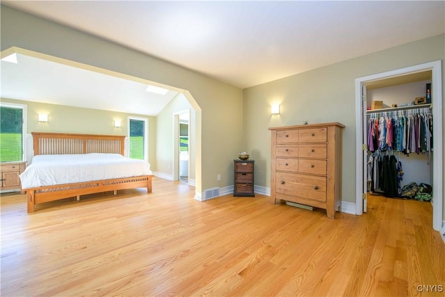 3200 Ransom Rd, Pompey, NY 13078 - bedroom with a walk in closet, light wood-style flooring, arched walkways, and a closet