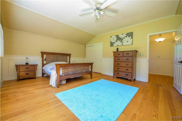 3200 Ransom Rd, Pompey, NY 13078 - bedroom with a wainscoted wall, light wood-style flooring, a decorative wall, lofted ceiling, and a closet