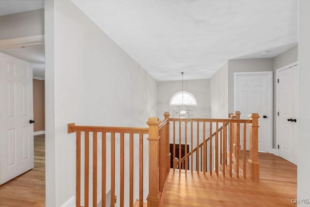 3306 Glen Abbey, Lysander, NY 13135 - corridor featuring an upstairs landing, wood finished floors, and a chandelier