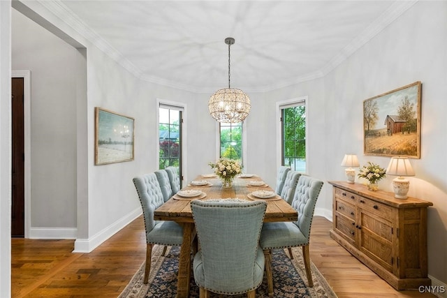 3306 Glen Abbey, Lysander, NY 13135 - dining space with healthy amount of natural light, a chandelier, ornamental molding, and wood finished floors