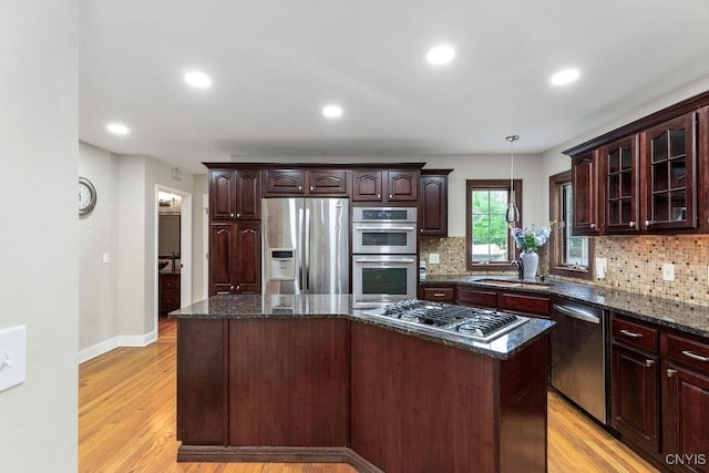3306 Glen Abbey, Lysander, NY 13135 - kitchen with stainless steel appliances, a kitchen island, backsplash, light wood-type flooring, and recessed lighting