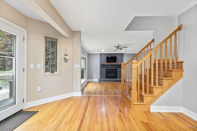 3306 Glen Abbey, Lysander, NY 13135 - foyer featuring a fireplace, wood finished floors, plenty of natural light, and a ceiling fan