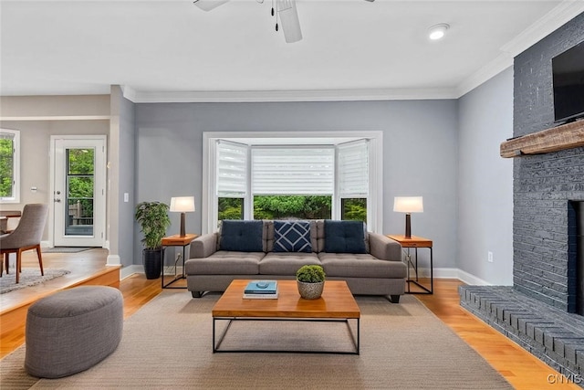 3306 Glen Abbey, Lysander, NY 13135 - living room with crown molding, ceiling fan, a fireplace, and wood finished floors