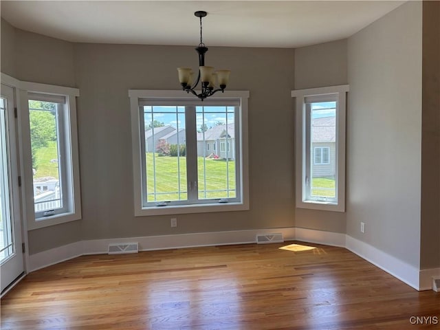 105 Austin Meadows Dr S, Manlius, NY 13104 - unfurnished dining area featuring a chandelier and light wood-type flooring