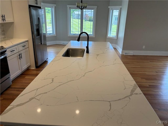 105 Austin Meadows Dr S, Manlius, NY 13104 - kitchen with stainless steel appliances, dark wood-type flooring, light stone counters, and white cabinetry