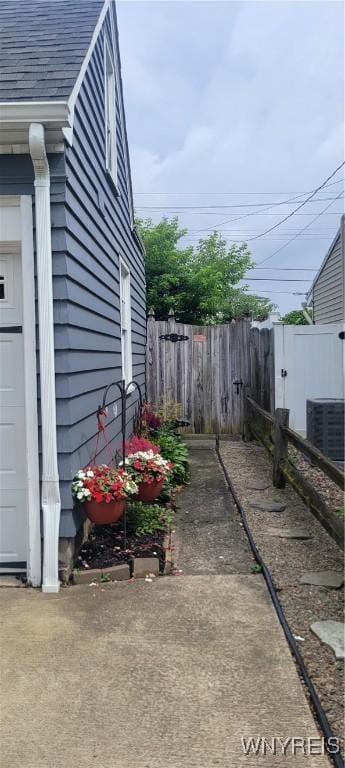 242 Northwood Dr, Tonawanda, NY 14223 - view of side of home with a central air condition unit and a garage