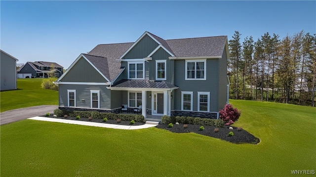 71 Woodthrush Trl, Orchard Park, NY 14127 - craftsman-style home featuring a standing seam roof, a front yard, roof with shingles, and stone siding