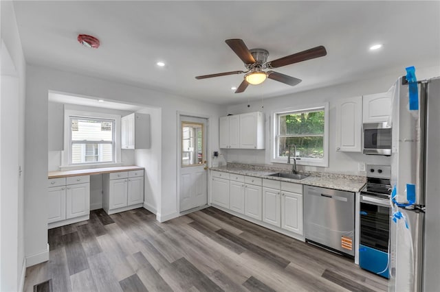 503 Main St, Oneonta, NY 13820 - kitchen with appliances with stainless steel finishes, white cabinets, a ceiling fan, recessed lighting, and light stone counters