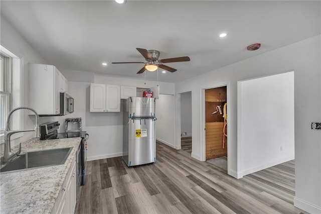 503 Main St, Oneonta, NY 13820 - kitchen with appliances with stainless steel finishes, a ceiling fan, dark wood-style floors, white cabinetry, and recessed lighting