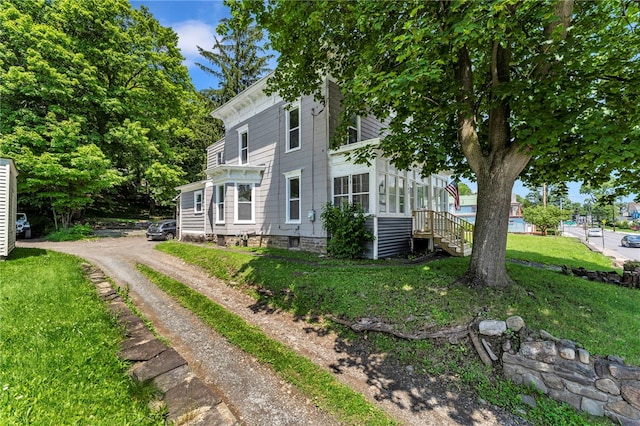503 Main St, Oneonta, NY 13820 - view of side of home with a yard and a sunroom