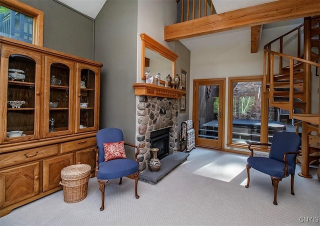 1929 Chard Rd, Cazenovia, NY 13035 - living room featuring vaulted ceiling, carpet floors, a stone fireplace, and stairway