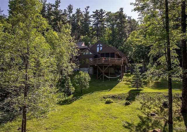 1929 Chard Rd, Cazenovia, NY 13035 - back of house featuring a wooden deck, a yard, and a view of trees