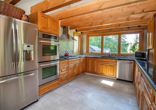 1929 Chard Rd, Cazenovia, NY 13035 - kitchen featuring stainless steel appliances, wall chimney range hood, tasteful backsplash, beamed ceiling, and brown cabinetry