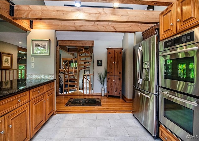 1929 Chard Rd, Cazenovia, NY 13035 - kitchen featuring stainless steel appliances, brown cabinets, dark stone counters, and light tile patterned floors
