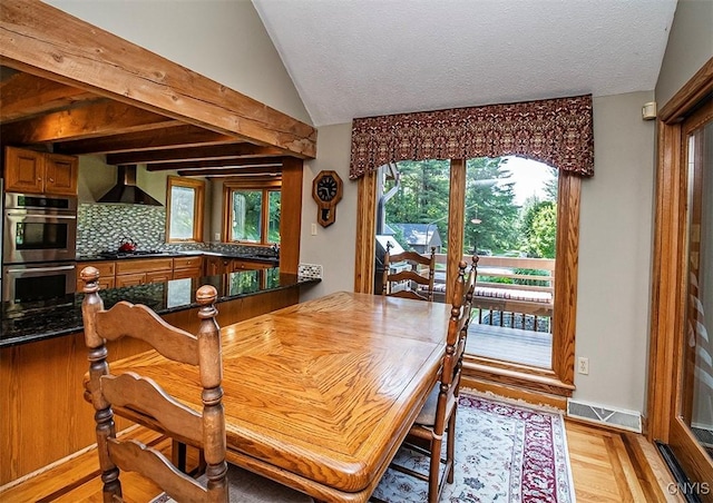 1929 Chard Rd, Cazenovia, NY 13035 - dining area with lofted ceiling, light wood finished floors, and a textured ceiling