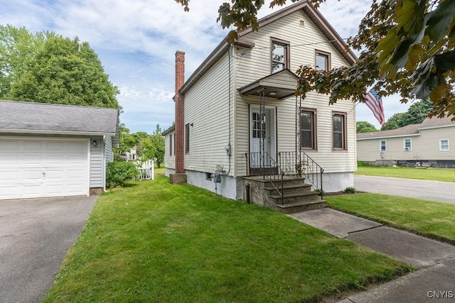 81 E 10th St, Oswego, NY 13126 - traditional home featuring a garage, a front lawn, and driveway