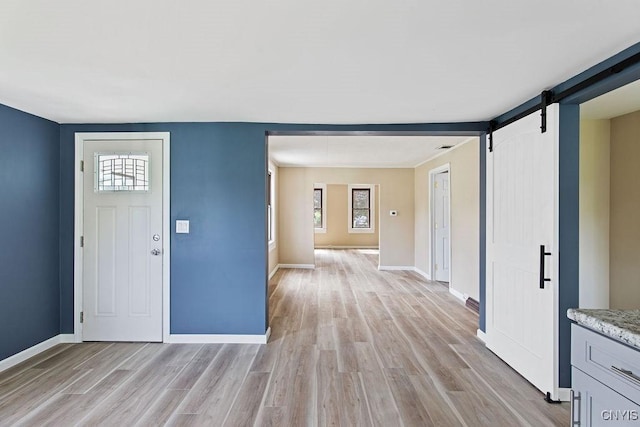 81 E 10th St, Oswego, NY 13126 - entryway with a barn door and light wood-type flooring