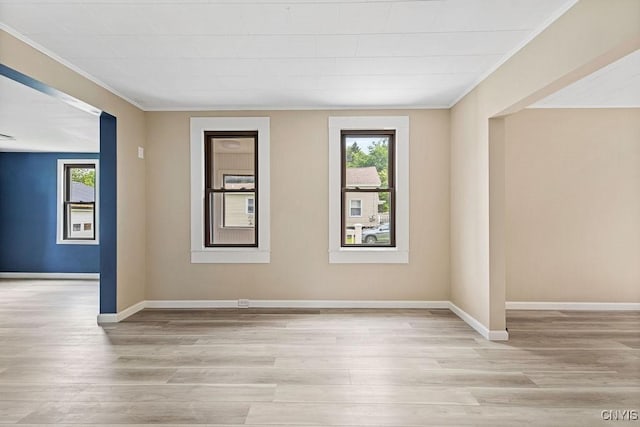 81 E 10th St, Oswego, NY 13126 - spare room with healthy amount of natural light, ornamental molding, and wood finished floors
