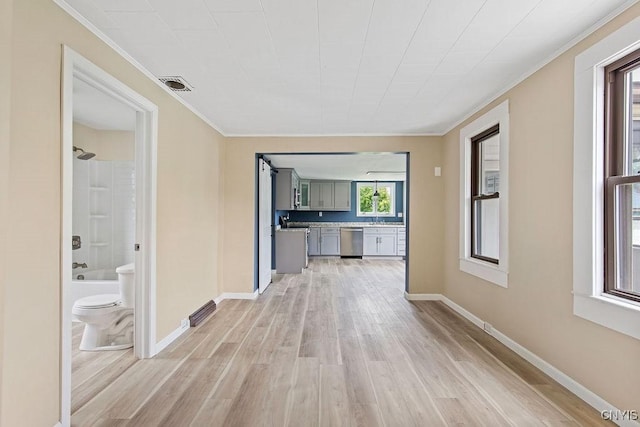 81 E 10th St, Oswego, NY 13126 - unfurnished living room with light wood-style floors and ornamental molding