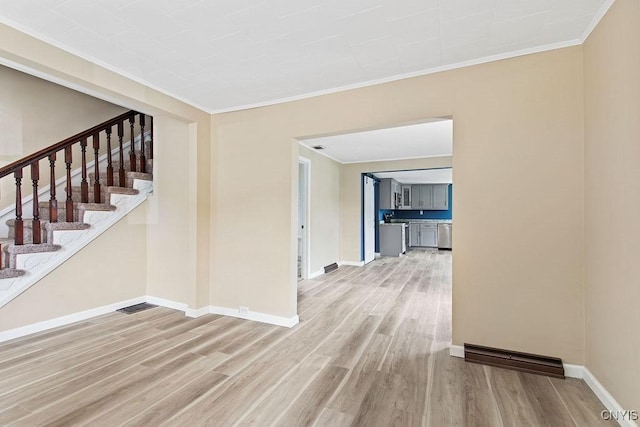 81 E 10th St, Oswego, NY 13126 - corridor featuring wood finished floors, crown molding, and stairway