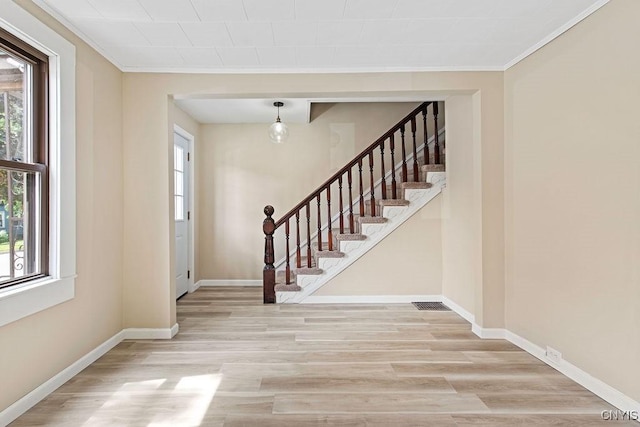 81 E 10th St, Oswego, NY 13126 - foyer featuring stairs, wood finished floors, and ornamental molding