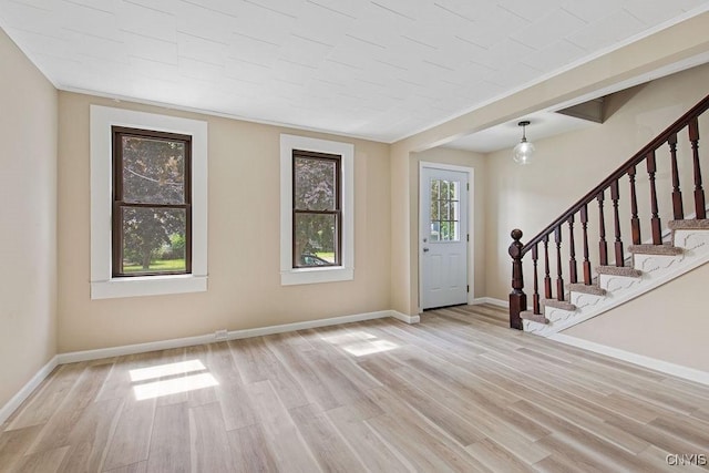 81 E 10th St, Oswego, NY 13126 - entrance foyer featuring light wood finished floors, stairway, and crown molding