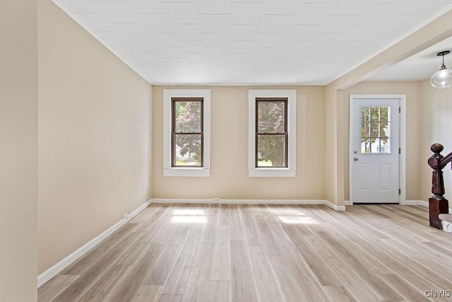 81 E 10th St, Oswego, NY 13126 - foyer entrance featuring light wood finished floors and crown molding