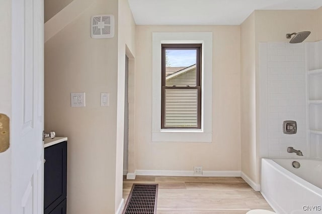 81 E 10th St, Oswego, NY 13126 - full bathroom with wood finished floors, vanity, and washtub / shower combination
