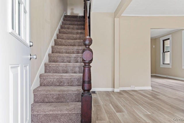 81 E 10th St, Oswego, NY 13126 - stairway with wood finished floors and ornamental molding